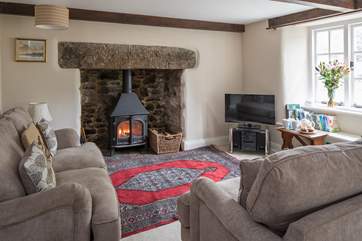 The sitting-room with its fabulous wood-burning stove is the perfect place to cosy up after a day of exploration.