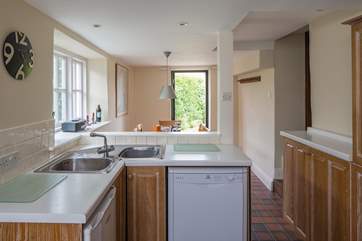 Looking back through the kitchen/dining-room and out to the patio-area and the delights which await beyond.