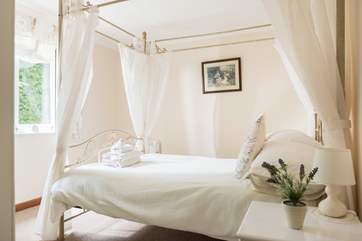 The pretty four-poster bed.