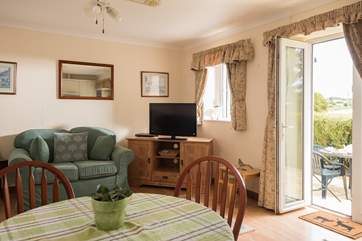 Room to relax and dine with doors straight out onto the patio terrace.