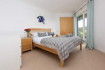 The master bedroom has doors that lead out to the patio and an en suite shower-room.