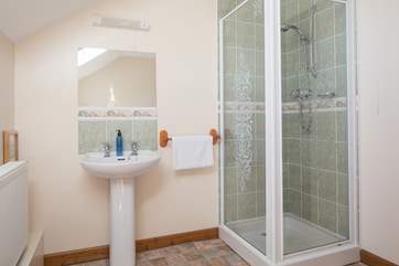 Family bathroom is equipped with a shower cubicle and a bath.