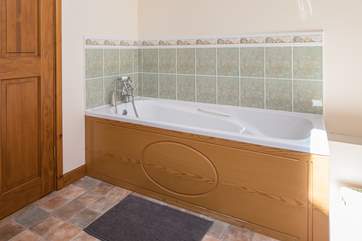 The bath in the family bathroom is perfect for relaxing and unwinding following a full day of adventure.