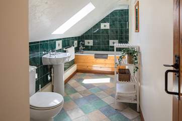 The family bathroom is a lovely place to slink back and relax immersed in a bath of bubbles.