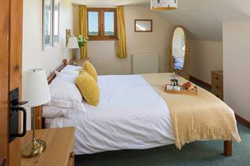 The master bedroom is extremely pretty and inviting.