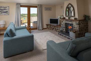 The wood-burner makes this inviting sitting-room the perfect place to snuggle up and enjoy a cosy night in.