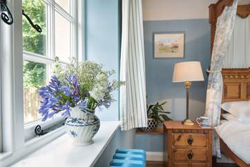 The bedroom overlooks the patio and gardens