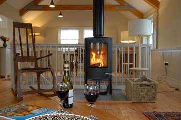 The gorgeous first floor open plan living-area with a roaring wood-burner.