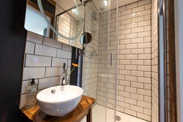 With a large shower, wash-basin and of course proper flushing toilet.