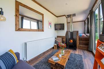 The open plan living-area is just gorgeous and if you ever get bored of the stunning views there is a TV with Amazon Firestick and a cosy wood-burner too.