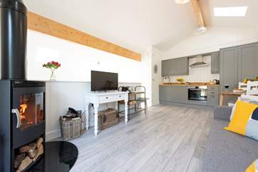 The open plan living space with TV and lovely big wood-burner.