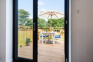 Looking out the patio doors to the deck and meadow beyond.