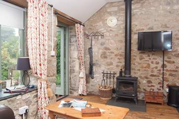 The sitting-area has a roaring wood-burner.