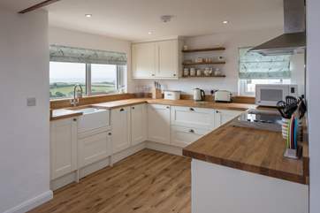 The spacious and well-equipped kitchen also makes the most of the stunning sea views. It almost makes washing up a pleasure!