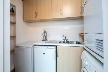 A very useful utility-area has an extra fridge, a freezer and both a washing machine and tumble-drier.