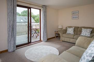 The sitting-room is super comfy, and opens directly onto your decked patio area.