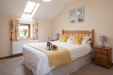 The light and airy main bedroom is super inviting.