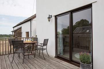 Looking back at the patio table and the doors into the sitting-room. You can just catch a glimpse of the fields beyond.