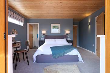 Looking from the deck into the master bedroom with the doors folded back.