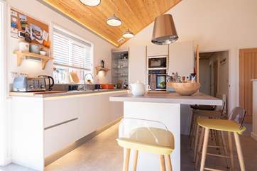 Sit and chat at the breakfast-bar while meals are prepared.