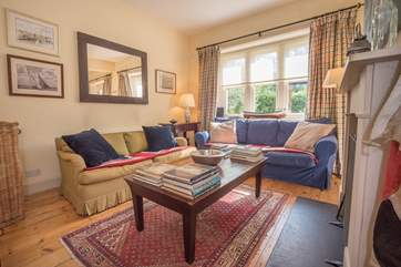 Open plan sitting/dining-room with patio doors leading to the pretty patio area.