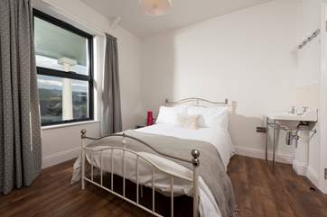 Lovely muted tones in Bedroom 2 which also has a wash-basin - very convenient.