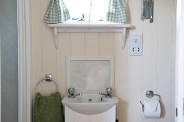 Complete with shower, wash-basin and proper flushing loo.