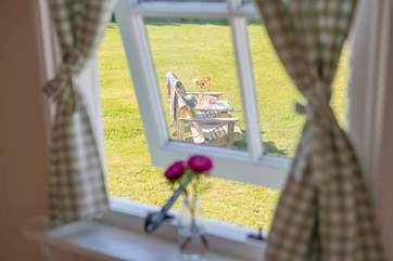 All of the windows look out onto the spacious meadow.