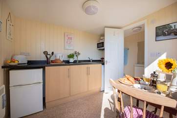 The kitchen includes a 2-ring hob, microwave and even a washing machine!