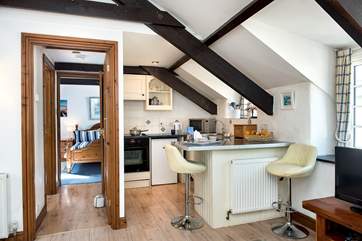 This spacious room houses the kitchen, dining and living areas.