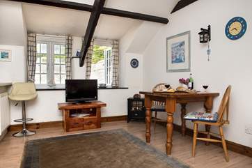 There is a breakfast-bar to one side and a dining-table to the other.