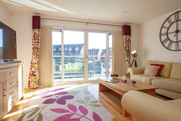 The first floor sitting-room is perfectly located with a balcony overlooking the marina.