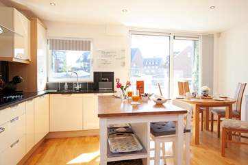 With doors to the balcony from the kitchen/dining-room this room is light and airy.
