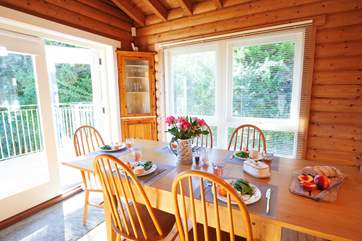 The open plan sitting/dining-room with doors leading out to the balcony - the perfect place for a family gathering.