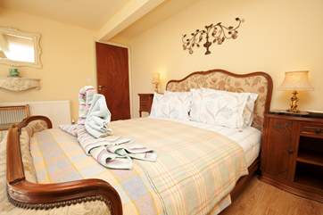 This double bedroom is located on the lower ground floor with doors leading out to the garden.