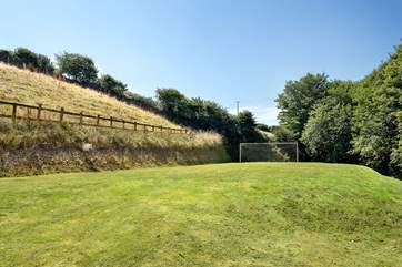 There's a large lawned area complete with football net.