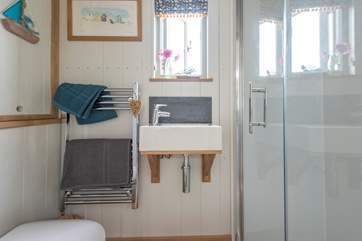 Complete with walk-in shower, wash-basin and proper flushing loo.