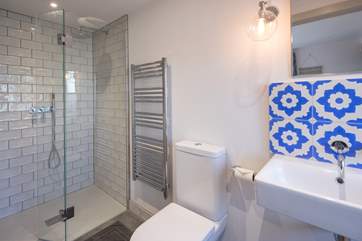 The en suite to Bedroom 5 is equipped with a large shower cubicle with tasteful design throughout.