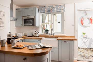 The well-equipped kitchen opens up to the patio