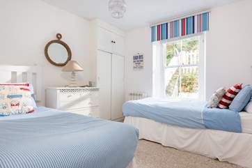 The twin bedroom on the first floor with classic coastal decor.