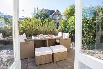 Doors from the sitting-room take you out to the patio area, complete with lovely patio furniture