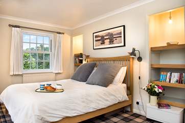 The master bedroom has views over the garden and the sea.