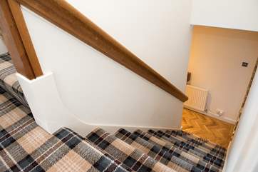 The stairs lead up to three bedrooms, family shower-room and extra loo.
