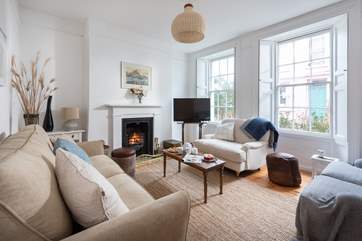 The light sitting-room with a cosy open fire.