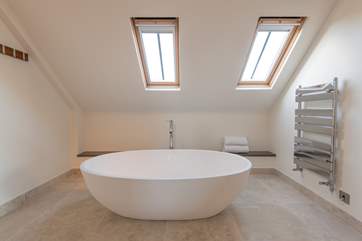 Relax in the free-standing bath and watch the stars twinkle through the skylights above