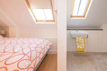 The double bedroom with en suite wet-room has restricted space and head height when sleeping two in this room