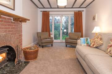 The doors from the sitting-room lead out into the large enclosed garden with outdoor seating, a place everyone can enjoy