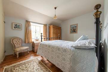 The bedrooms are in character with the cottage.