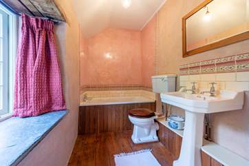 The bathroom houses a 3/4 length bath.