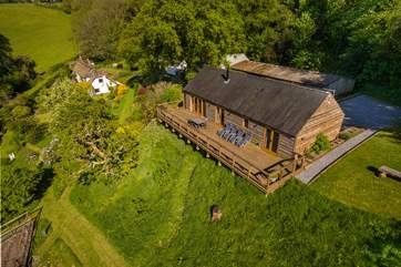 Larch Barn in the foreground with the owner's white Listed cottage in the background.
